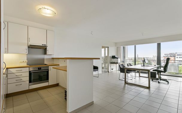 Tof appartement op de 7e verdieping met een super zicht ! 

Via de ruime inkom met apart toilet kom je binnen in de lefruimte van dit gezellige appartement met open ge&iuml;nstalleerde keuken. Het grote schuifraam biedt toegang tot het zonneterras waar je kan
